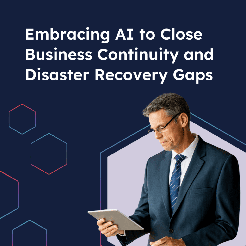 A middle-aged male wearing glasses and a navy suit looking down at the tablet he's holding with a quote above his head saying: "Embracing AI to close business continuity and disaster recovery gaps".